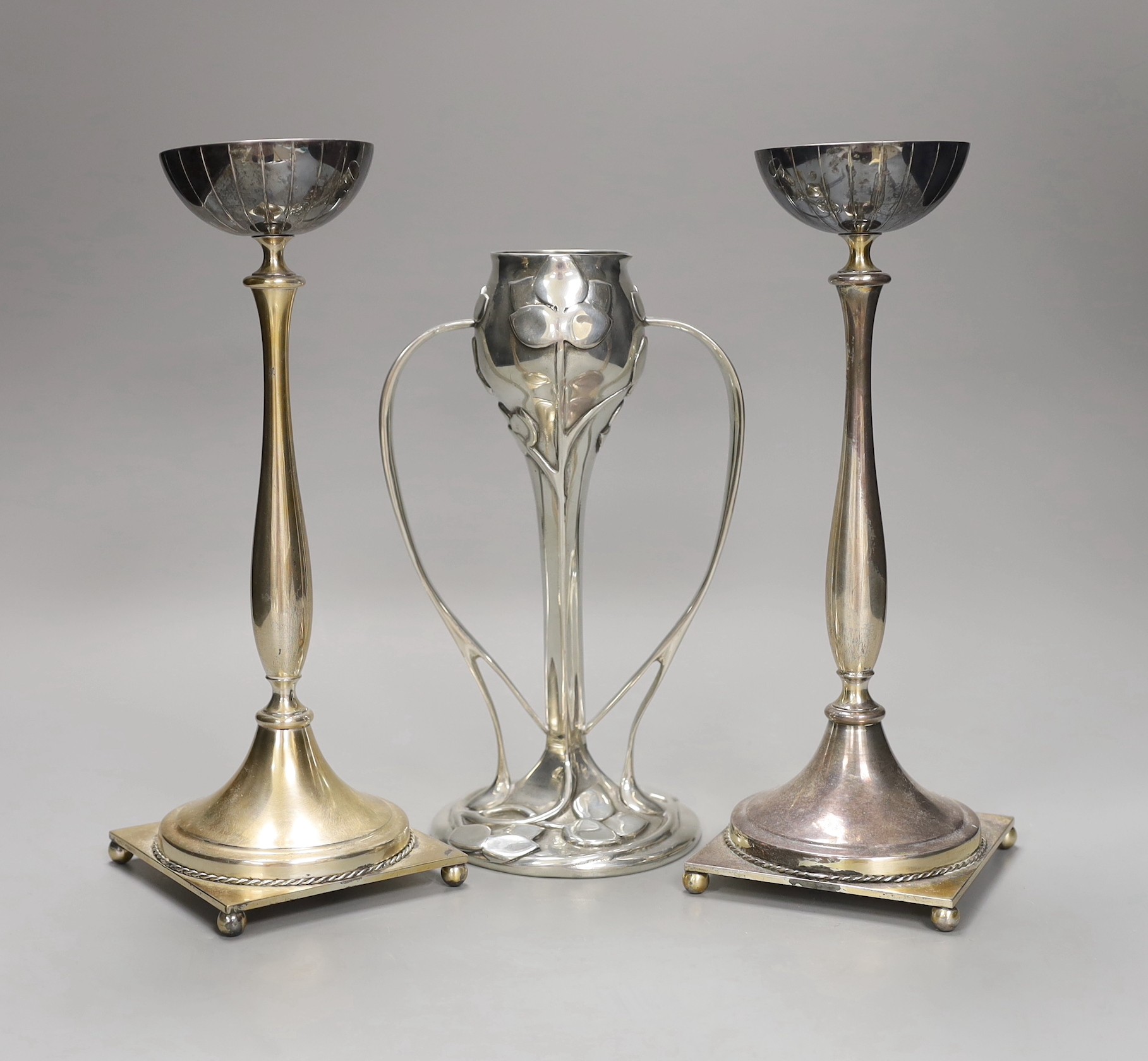 An Archibald Knox style pewter vase and two Swedish silver plated candlesticks, 26cm